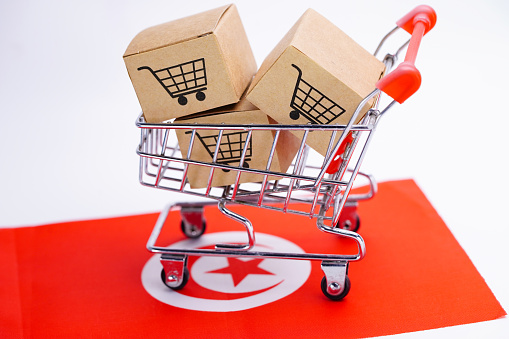 Box with shopping cart logo and Tunisia flag : Import Export Shopping online or eCommerce finance delivery service store product shipping, trade, supplier concept.