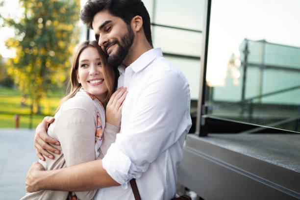 istock Happy young couple hugging and laughing outside 1176483004