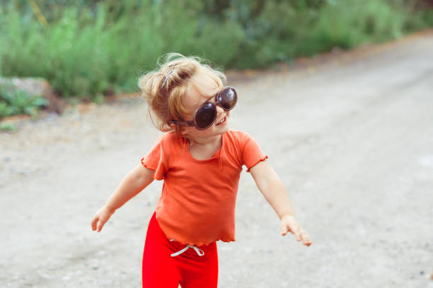 istock little girl dancing in glasses 1176485421