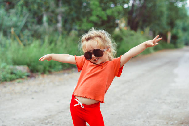 istock little girl dancing in glasses 1176485452