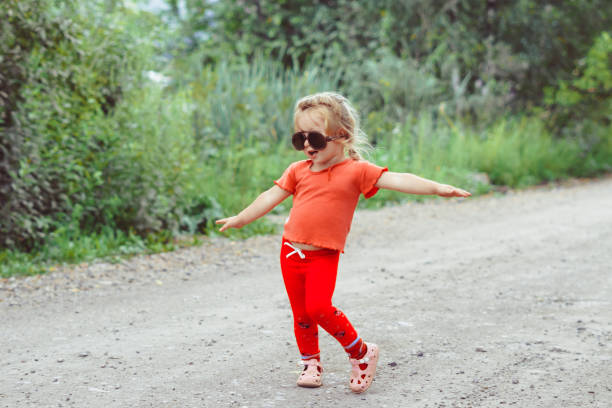 istock little girl dancing in glasses 1176485464
