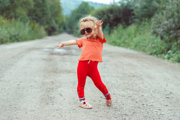 istock little girl dancing in glasses 1176485500