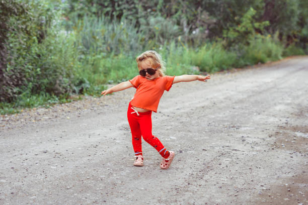 istock little girl dancing in glasses 1176485556