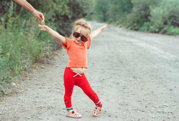little girl dancing in glasses stock photo