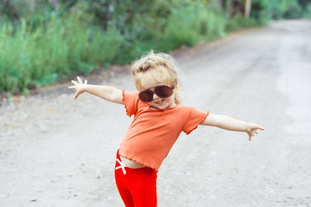 istock little girl dancing in glasses 1176485636