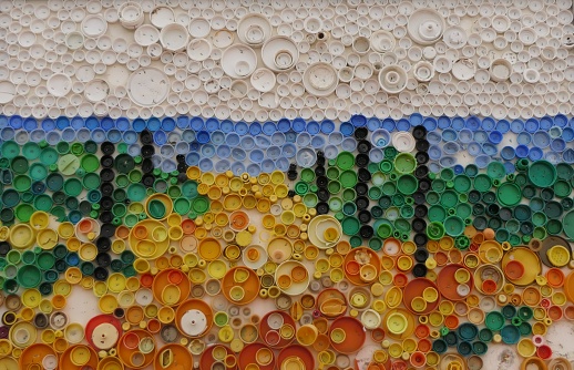 Mosaic made of plastic bottle caps found on the beach