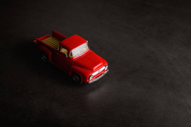 istock Red pickup model on the black floor 1176489550