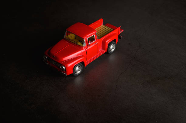 istock Red pickup model on the black floor 1176489569