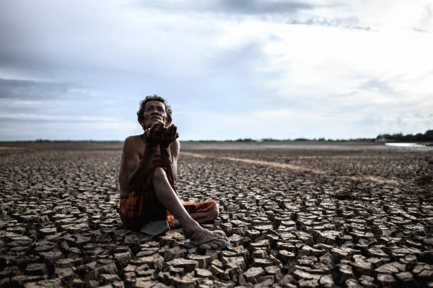 istock An elderly man was sitting asking for rain in the dry season, global warming, selective focus 1176491005