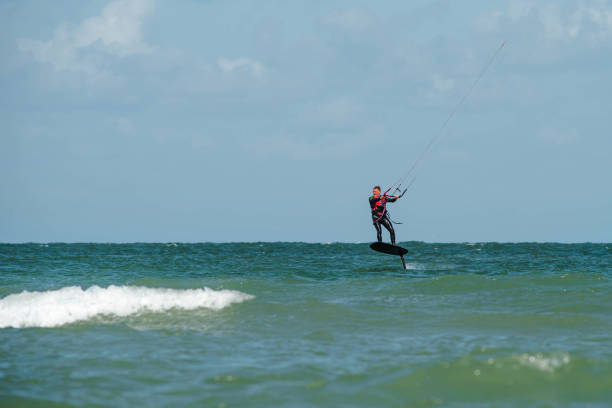 istock man doing kite surfing with a foil on the sea 1176491185