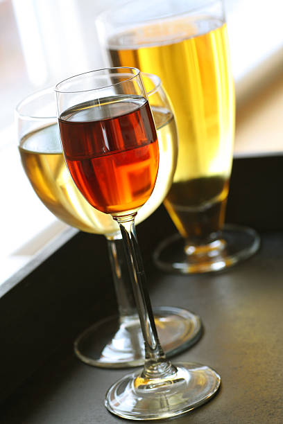 Three different types of glass with beverages inside stock photo