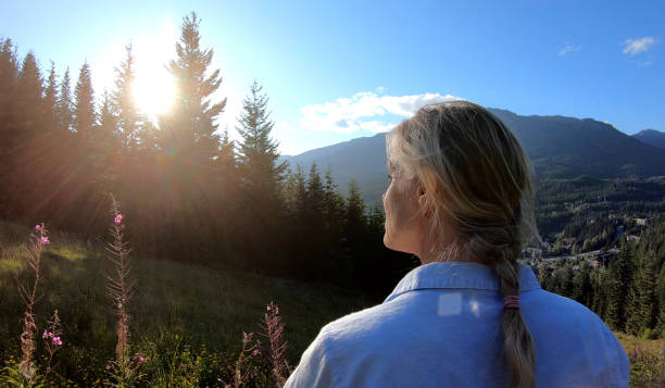 istock Couple walk through grassy meadow at sunrise 1176496017