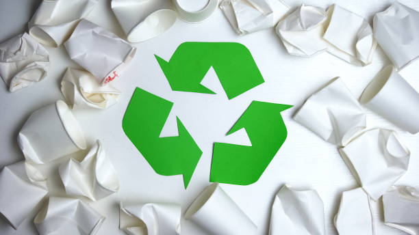 istock Crumpled disposable paper cups lying around recycling sign, save nature concept 1176496041