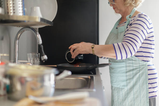 istock Senior woman preparing tomato sauce 1176496274
