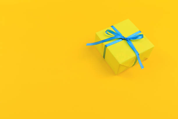 istock Gift box with ribbon and bow on color background and space for text. Top view 1176498160