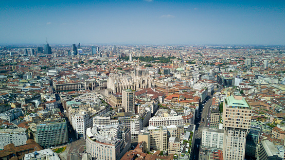 Aerial photo shooting with drone on Milan Center, the central business area of the city with new skyscrapers and iconic Cathedral and square of Duomo