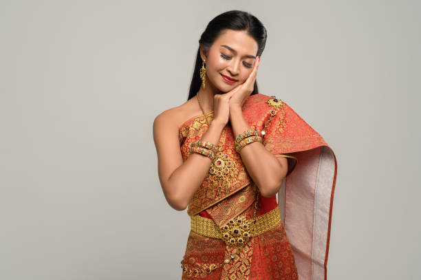 istock Women wearing Thai clothes and hands touching their faces 1176500832