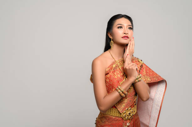 istock Women wearing Thai clothes and hands touching their faces 1176500891