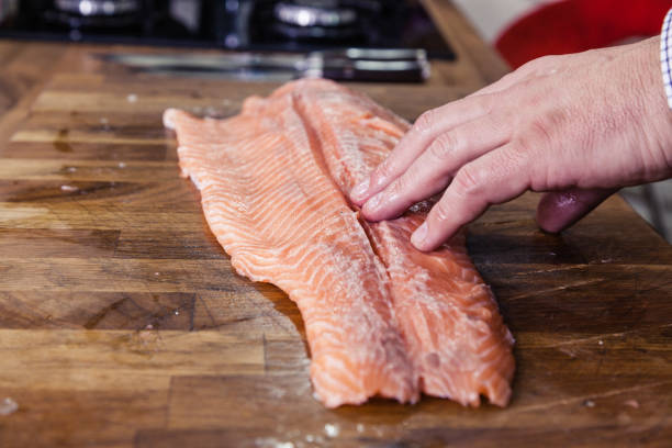 istock Clos-up of man preparing salmon in the kitchen. 1176501993