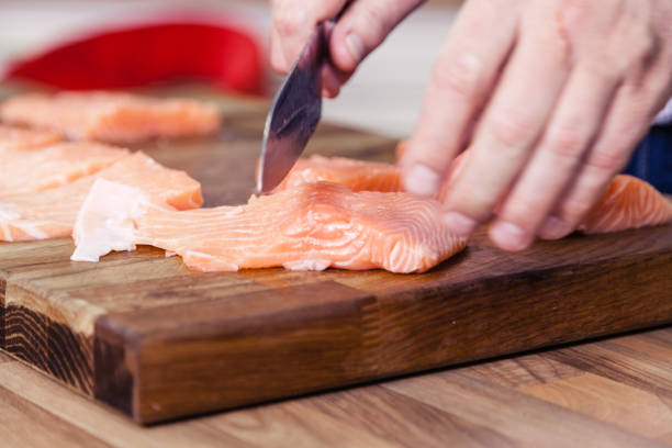 istock Slicing salmon fillets. 1176502457