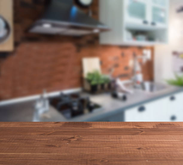 wooden table top and blur kitchen room of the background - domestic kitchen kitchen sink contemporary counter top imagens e fotografias de stock