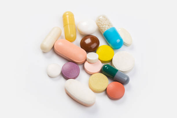 istock Assorted pharmaceutical medicine pills, tablets and capsules.Heap of assorted various medicine tablets and pills different colors on white background. 1176505576