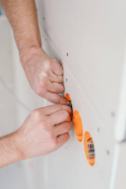 istock Handyman or electrician checking electric wiring 1176509528