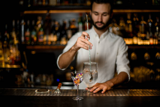 istock Bartender stirs an alcohol cocktail with bar spoon 1176510637
