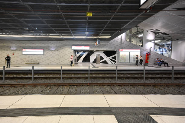 Scene Of Advertisement Sign, People Sitting Down, Waiting For Train, Walking Around, Looking Around, Talking To One Another, Departing After Arrival At Train Arrival And Departure Platform In Munich Bavaria Germany Europe