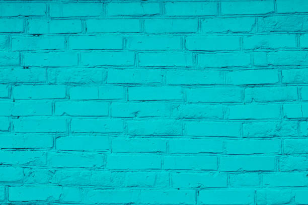 istock Bright turquoise painted uneven brick wall. Green bricks background. Decorative tile surface. Rough brickwork. Pattern, grunge texture. Copy space. 1176510987