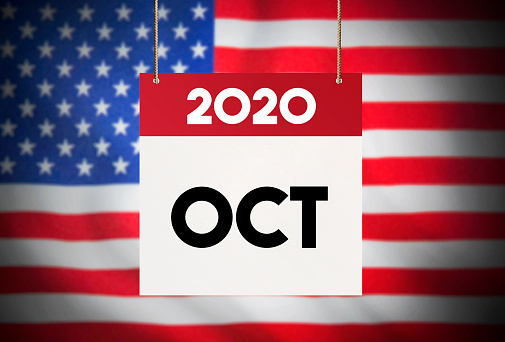 Calendar standing in front of the American flag and showing October 2020 Stock Image
