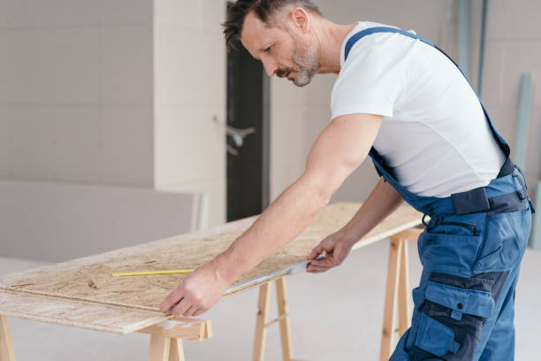 istock Worried builder checking measurements on a board 1176511602