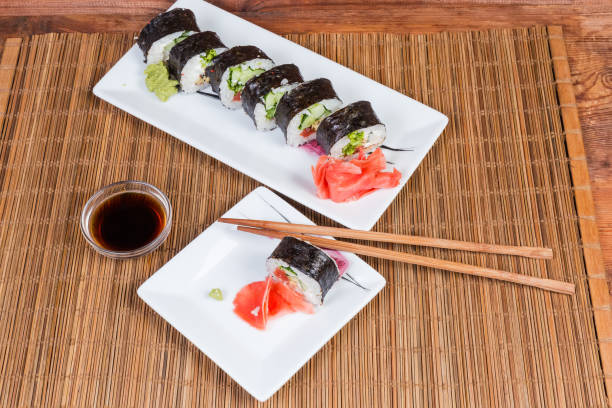 istock Top view of sushi on rectangular plates, condiments, chopsticks 1176513211