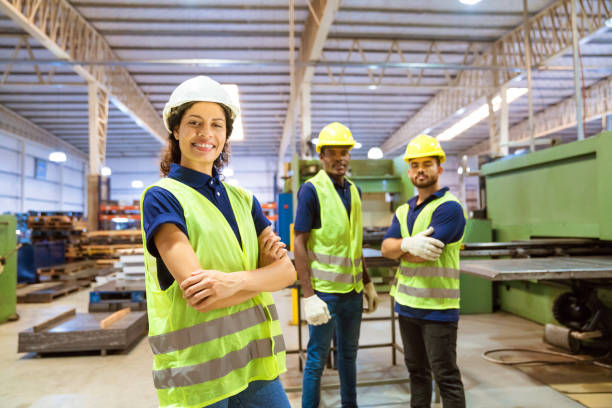 istock Smiling female engineer against male colleagues 1176513890