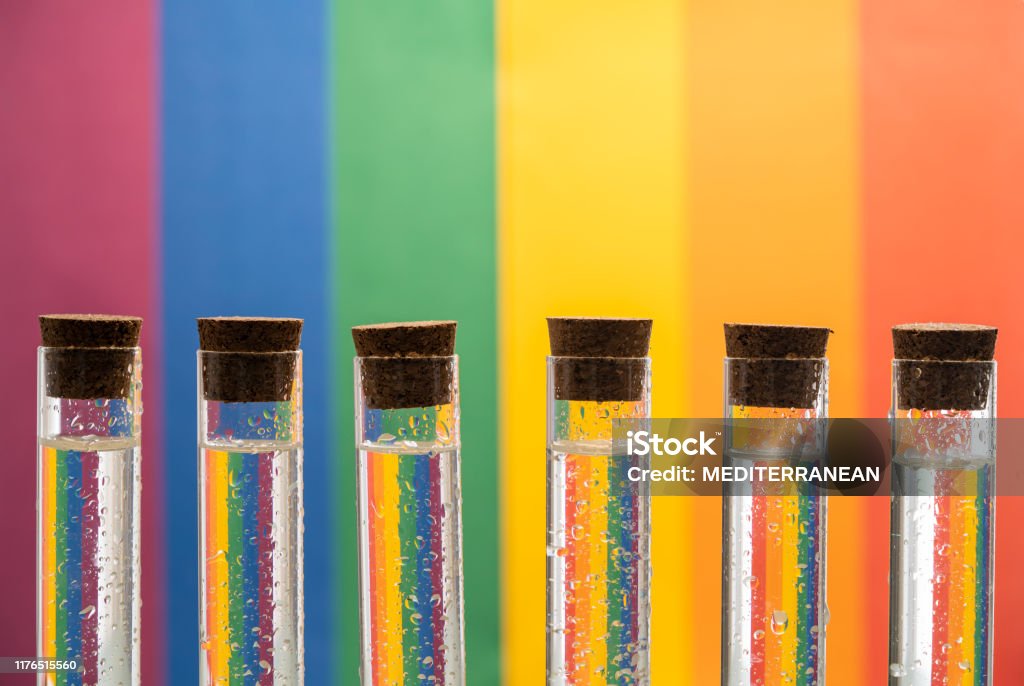 Lesbian Gay LGBT pride flag in test tubes Lesbian Gay LGBT pride flag with test tubes row reflection in water and cork plugs Science Stock Photo