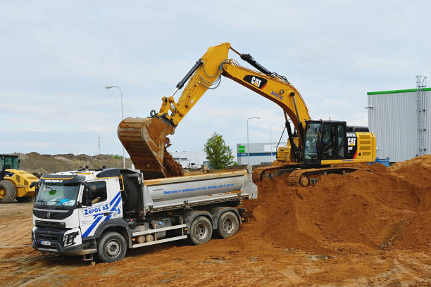 Excavators are digging and loading the excavation to truck stock photo