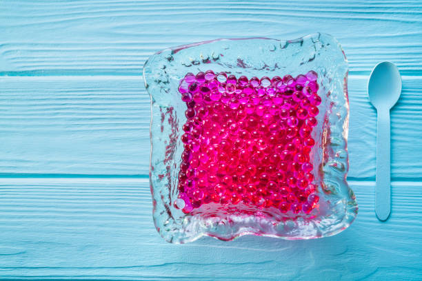 istock Pink spherification futuristic food concept on blue 1176516221