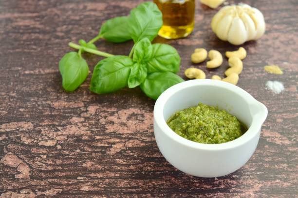 istock Fresh basil cashew pesto on wooden background 1176517639