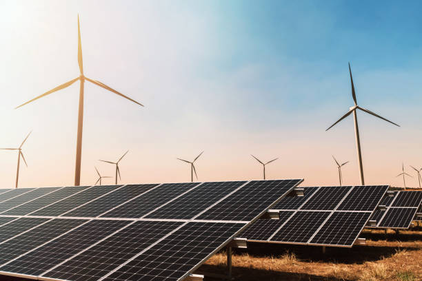 istock clean energy concept. solar panel with wind turbine and blue sky 1176517840