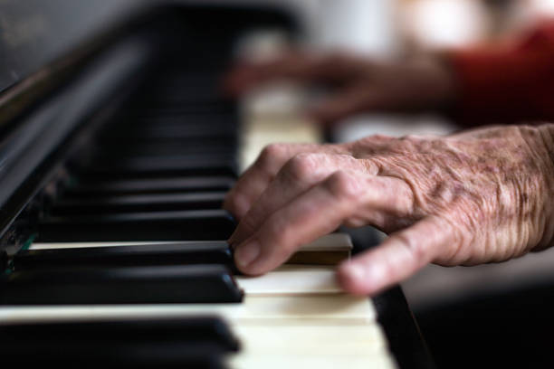 istock Piano being played by wrinkled, arthritic hands 1176521619