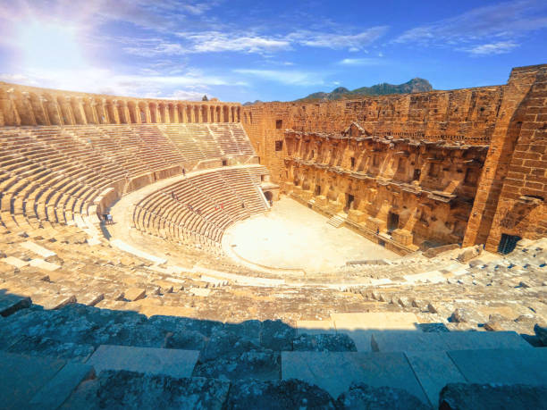 aspendos amphitheater close-up inside in the summertime with sunshine, turkey, serik. - amphitheater stock-fotos und bilder