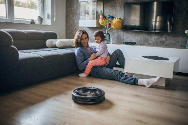 istock Family relaxing time while vacuum cleaner works 1176523495