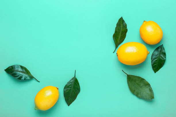 istock Mint green background with ripe lemons. Flat lay style 1176524145