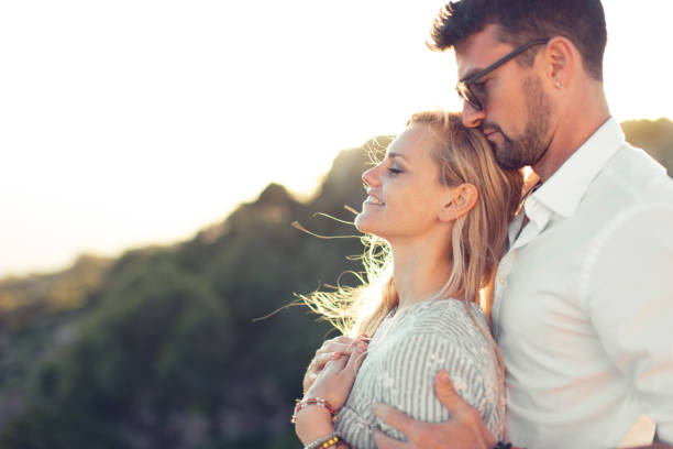 istock Young man holding daydreaming girlfriend by shoulder in nature 1176527051