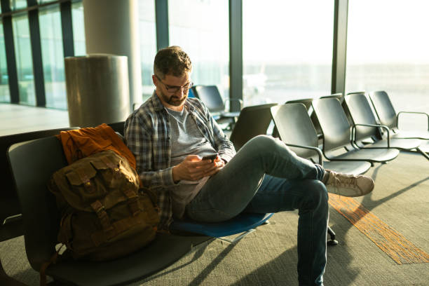 istock Waiting for flight at airport lounge and using mobile phone 1176527546