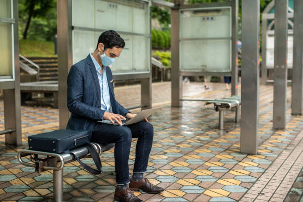 istock Businessman with surgical mask waiting for a bus 1176527612
