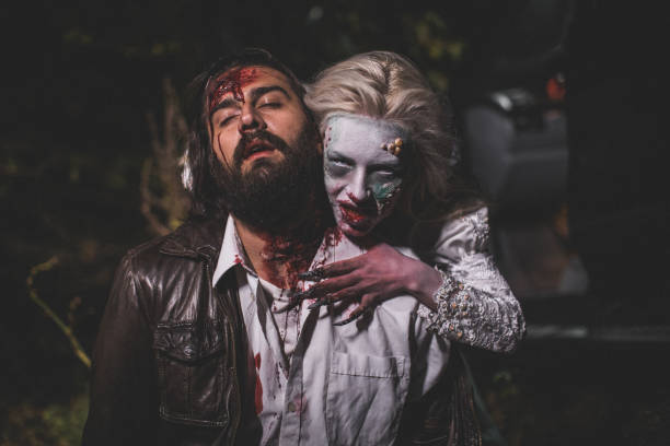 Witch attacked a man at night Man and woman, she masked herself in a scary witch for Halloween, attacking a man. male vampire biting his victim stock pictures, royalty-free photos & images