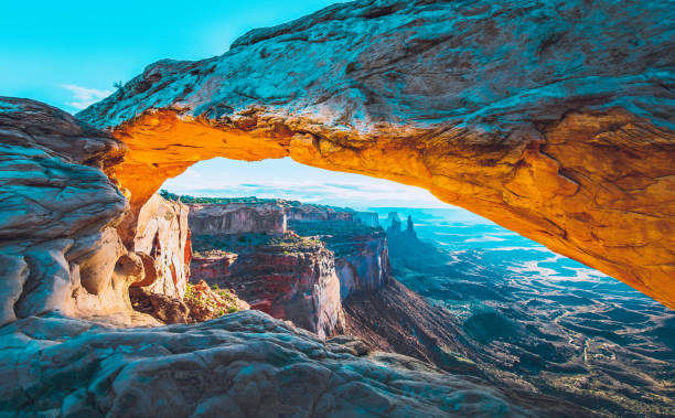 Mesa Arch Sunrise The sunrise at the Mesa Arch in the Canyonlands National Park makes the arch glow, Utah, USA. natural landmark stock pictures, royalty-free photos & images