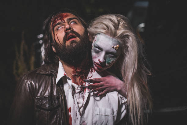 Evil witch attacked a man at night Man and woman, she masked herself in a scary witch for Halloween, attacking a man. male vampire biting his victim stock pictures, royalty-free photos & images