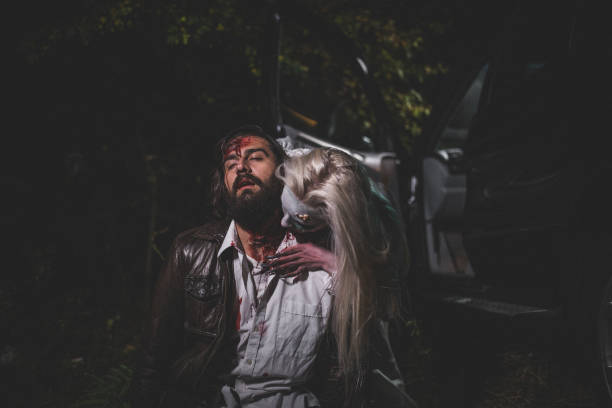 Witch attacked a man Man and woman, she masked herself in a scary witch for Halloween, attacking a man. male vampire biting his victim stock pictures, royalty-free photos & images